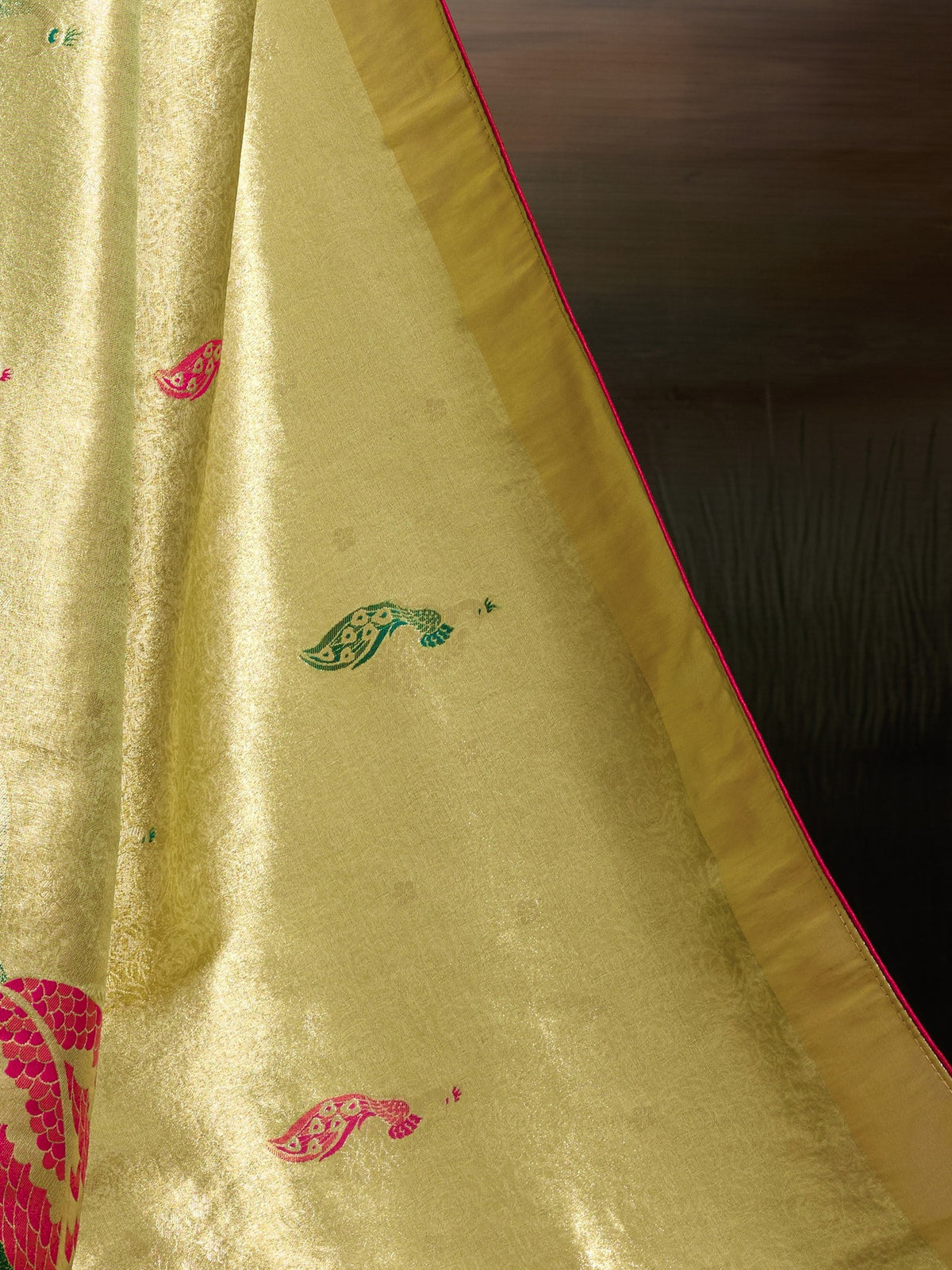 Pallu detail of lime green banarasi silk saree showing woven motif design and zari border