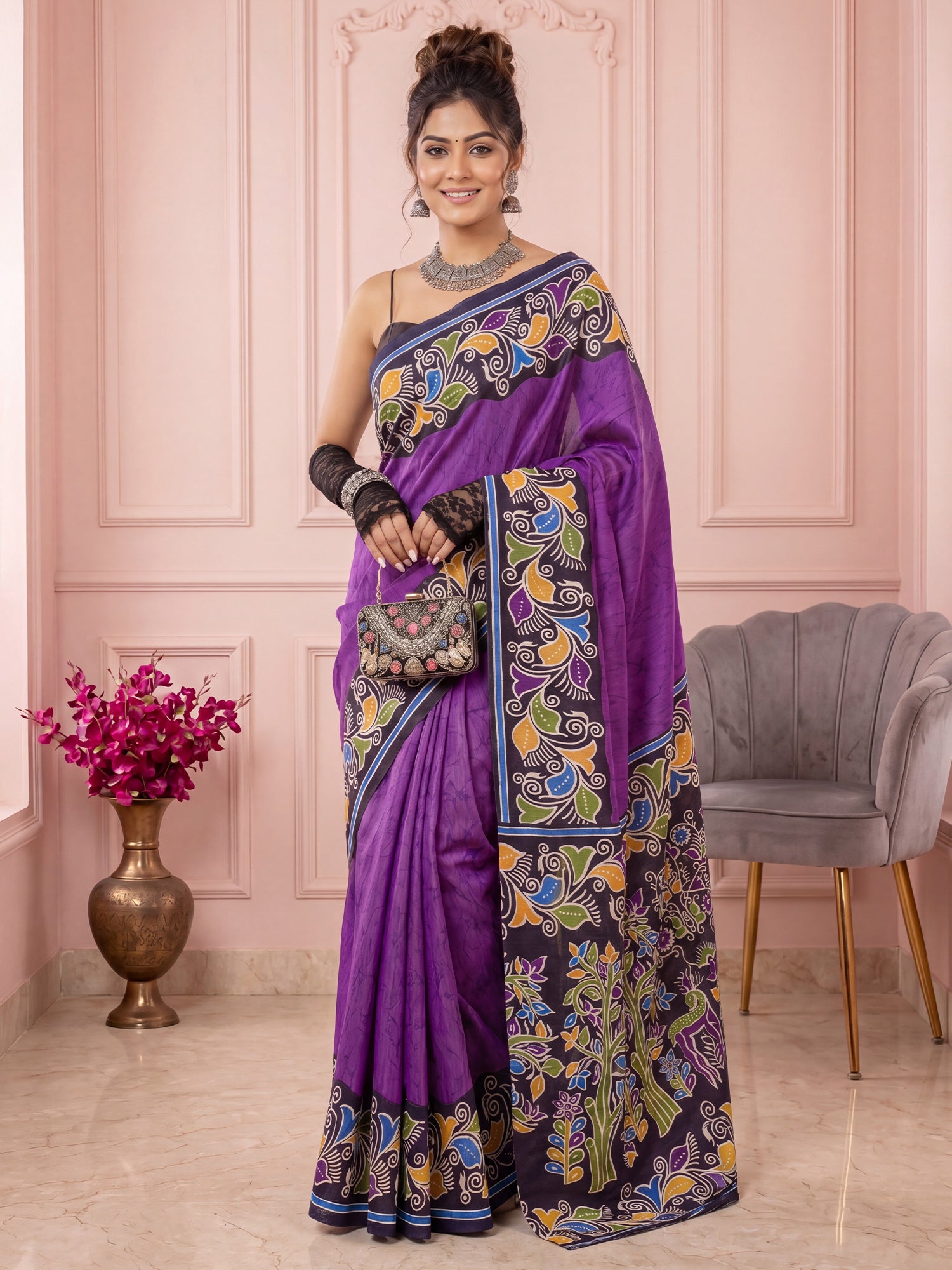 Woman wearing purple cotton blend saree with kalamkari narrative motif work and navy blue blouse