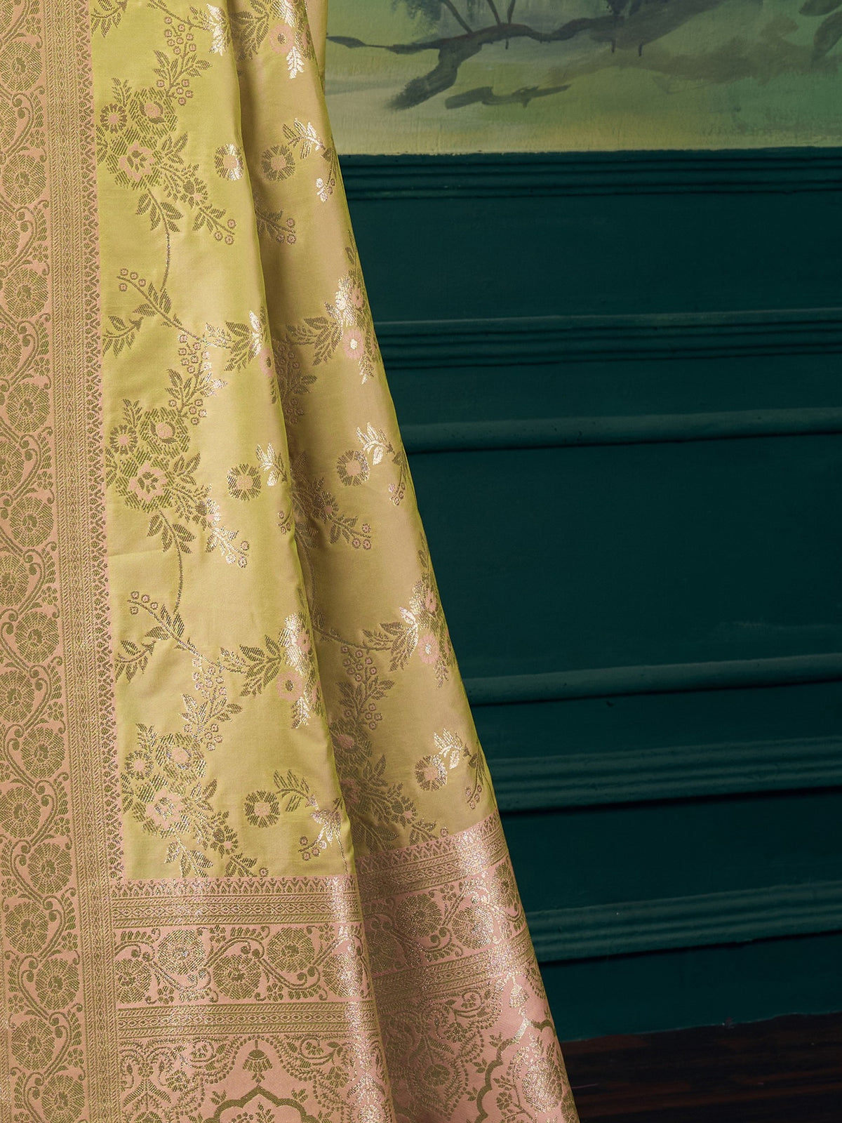 Pallu detail of lime green banarasi silk saree showing woven motif design and zari border