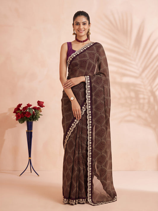 Woman wearing wine georgette saree with bandhani tie-dye dot work and purple blouse
