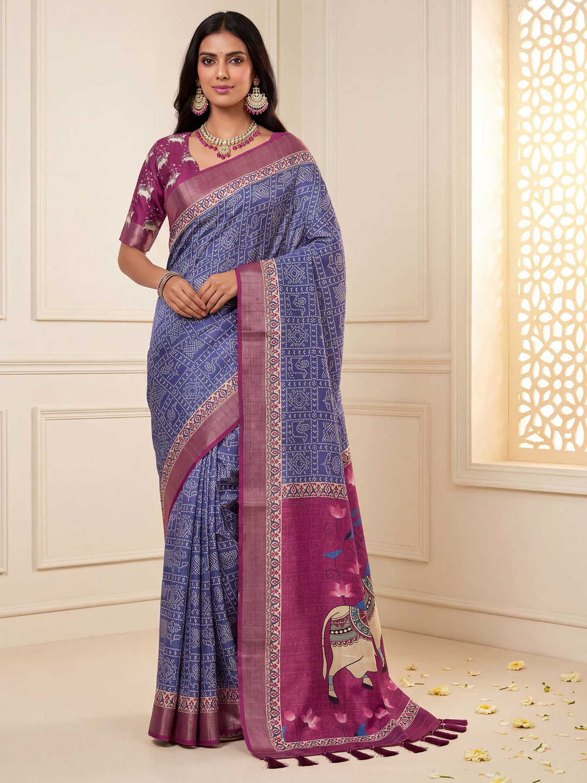 Woman wearing blue silk blend saree with madhubani folk-art motifs and magenta blouse