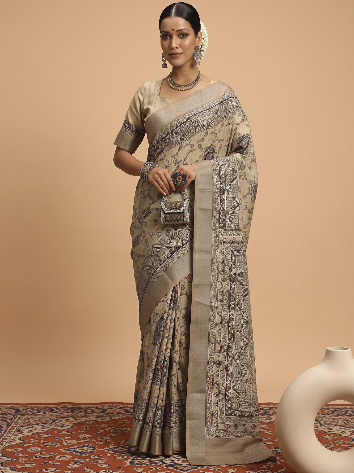 Woman wearing cream satin silk saree with hand block-printed motifs and cream blouse