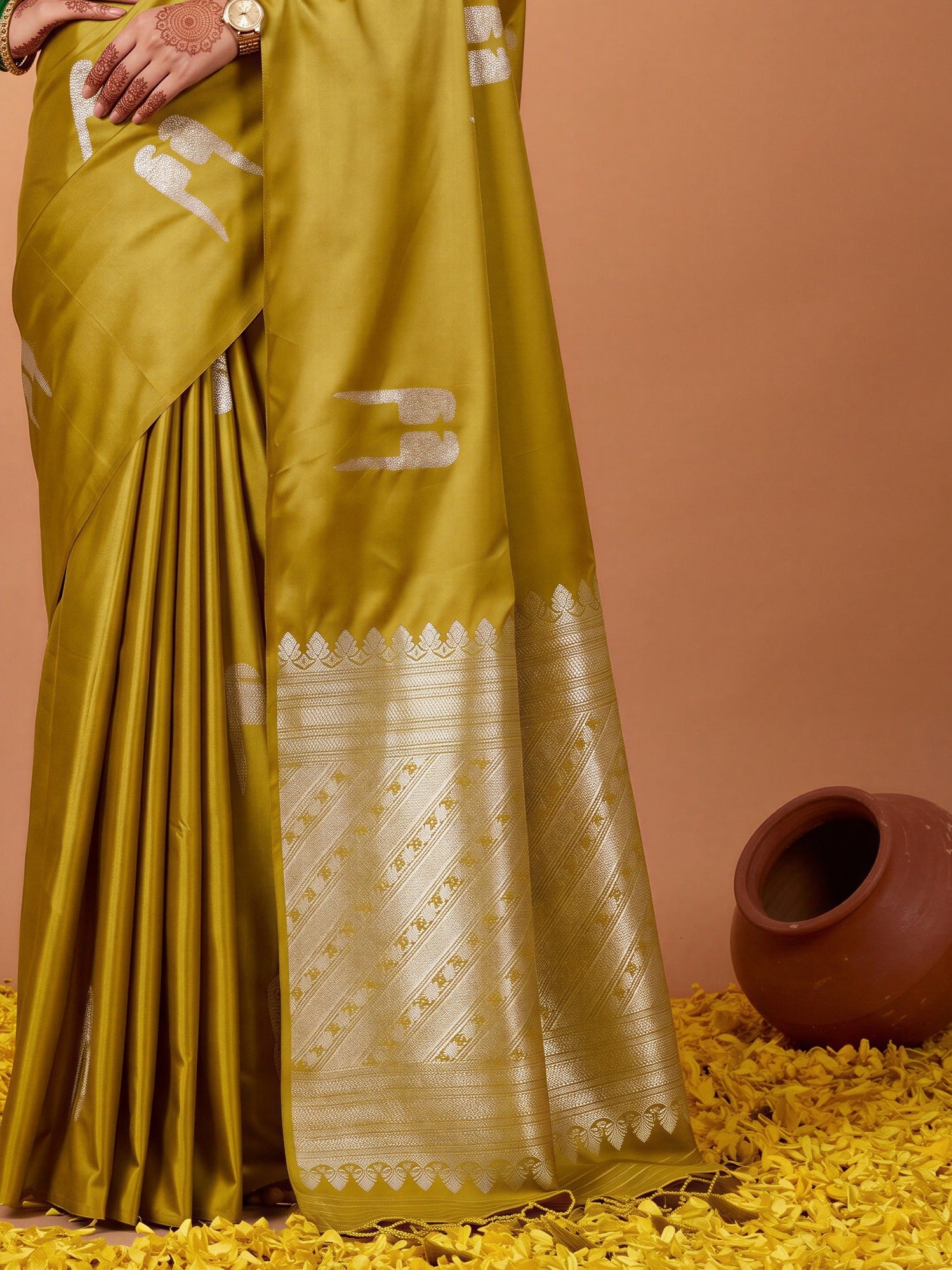 Pallu detail of olive satin saree showing botanical floral and leaf design and zari border