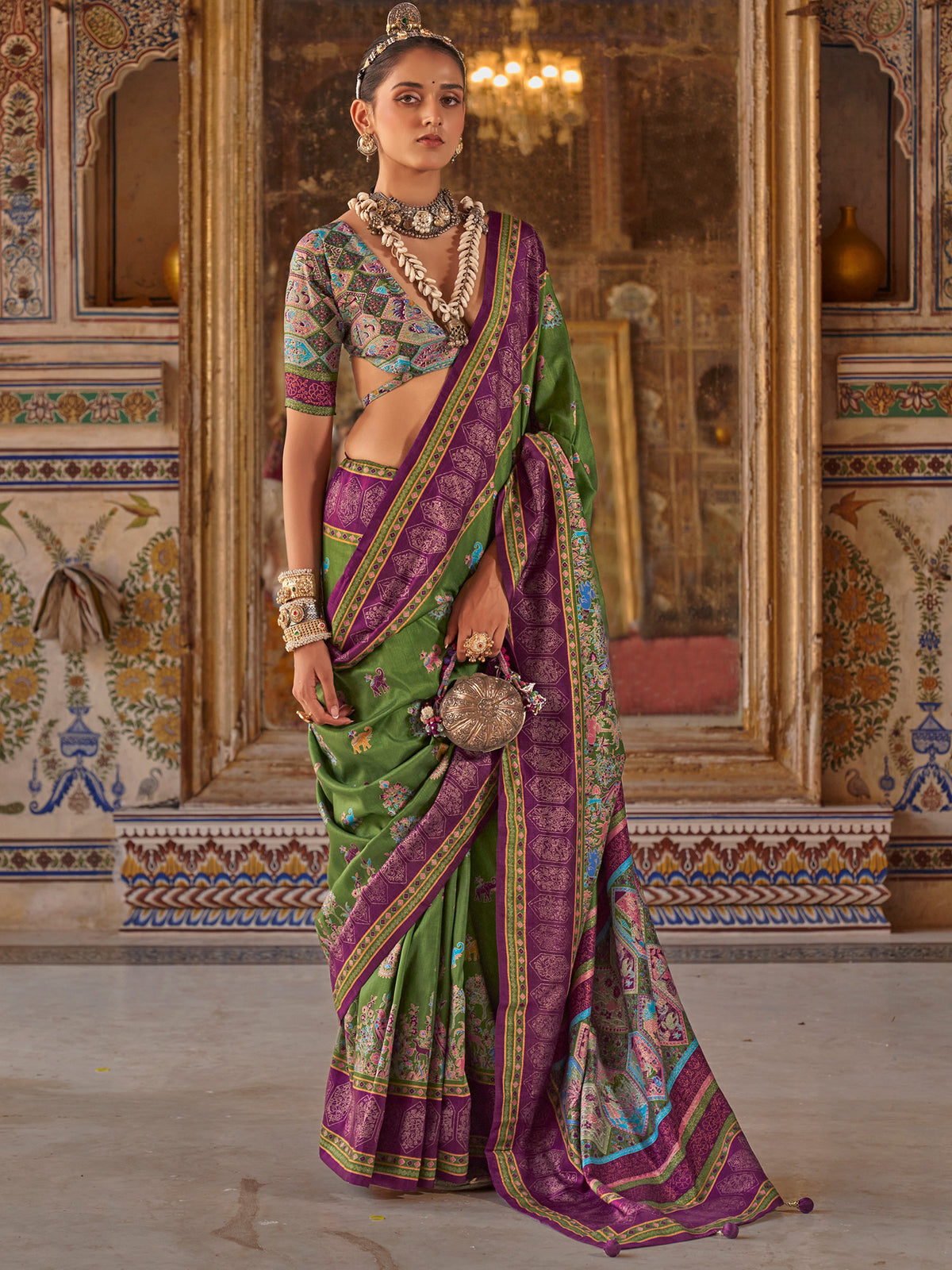 Woman wearing green silk blend saree with traditional indian motif work and multicolored blouse