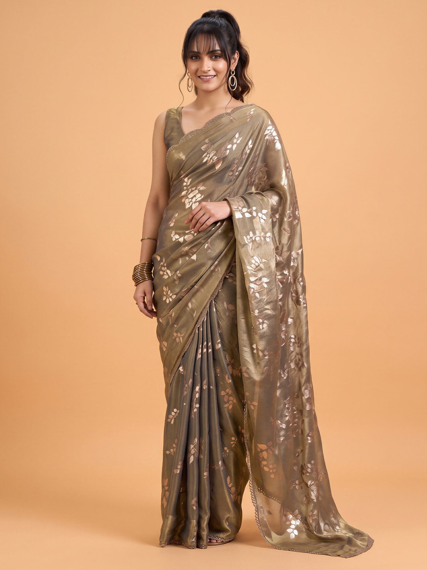 Woman wearing metallic satin silk saree with metallic foil print work and metallic blouse
