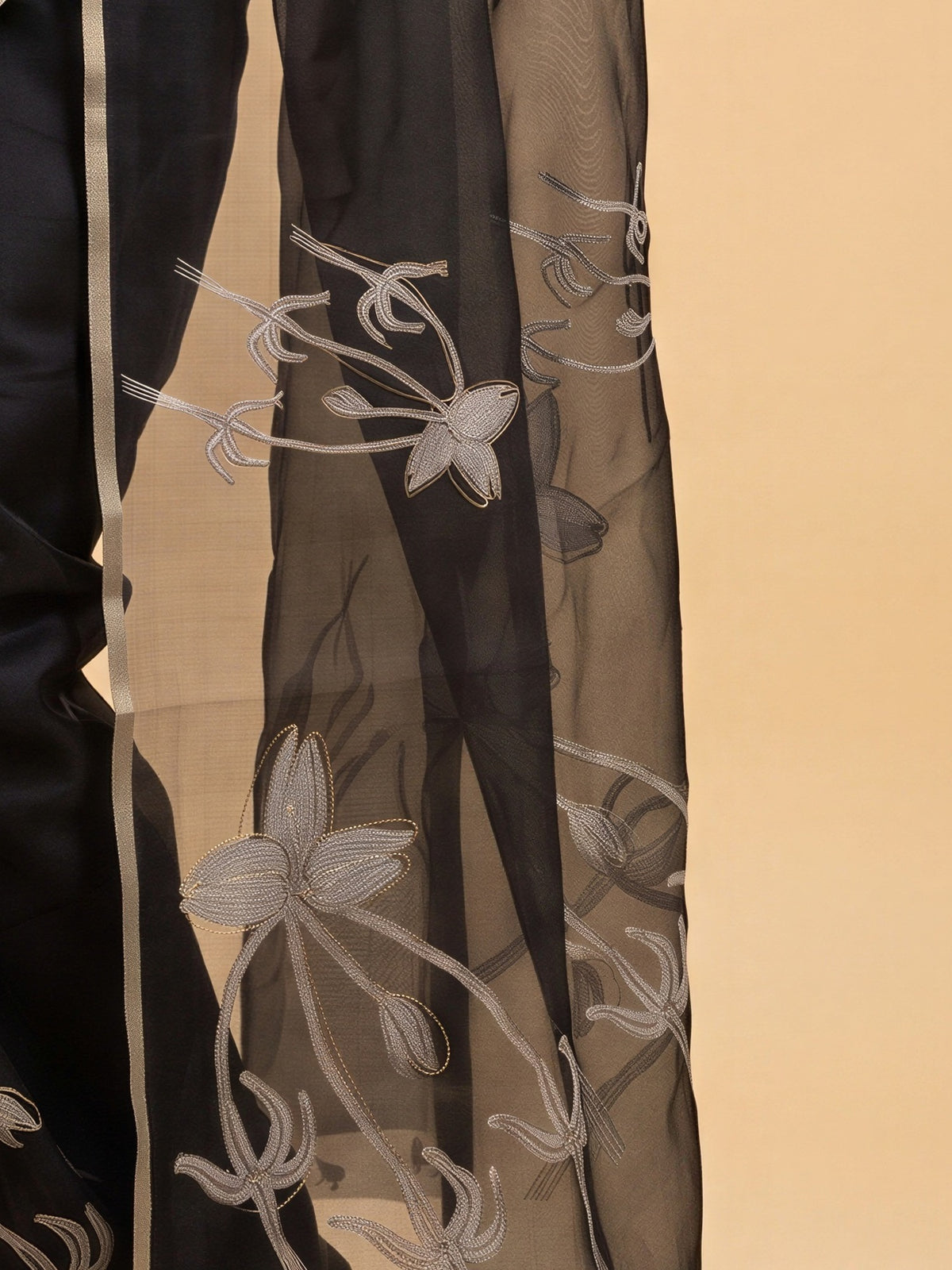 Pallu detail of black organza saree showing abstract contemporary design and zari border