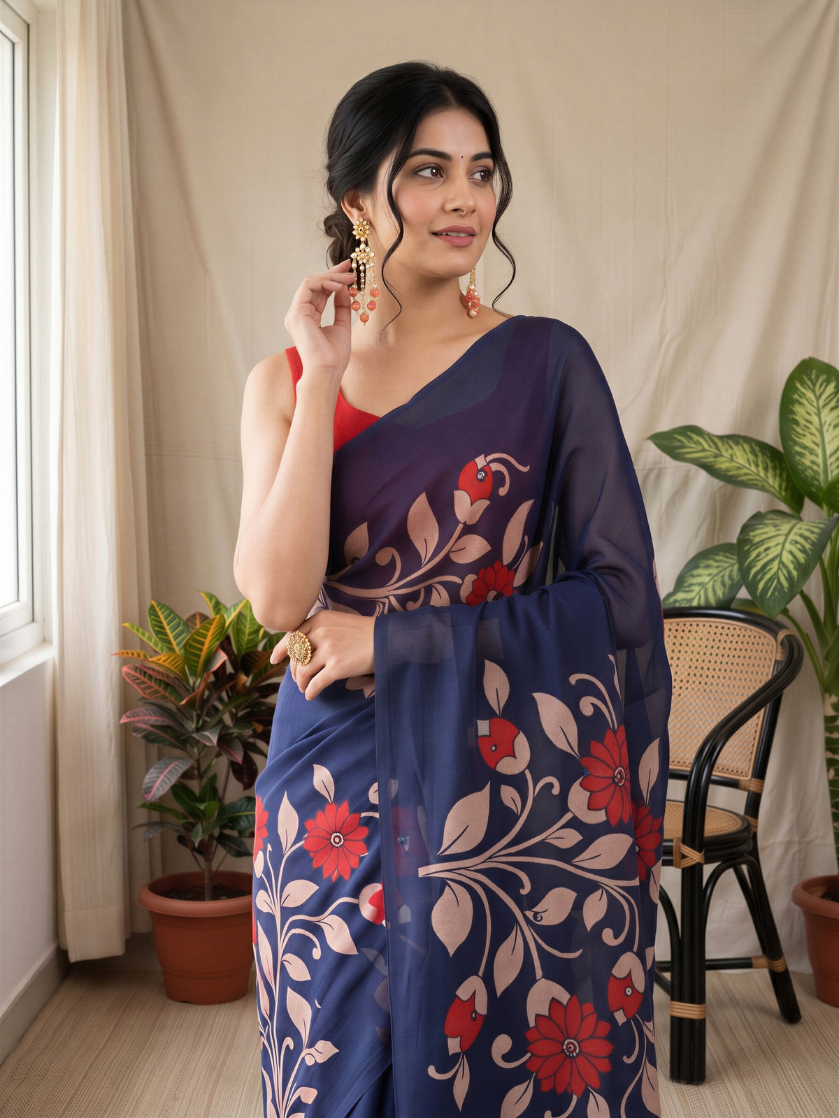 Woman wearing navy blue linen blend saree with all-over floral design and coral blouse