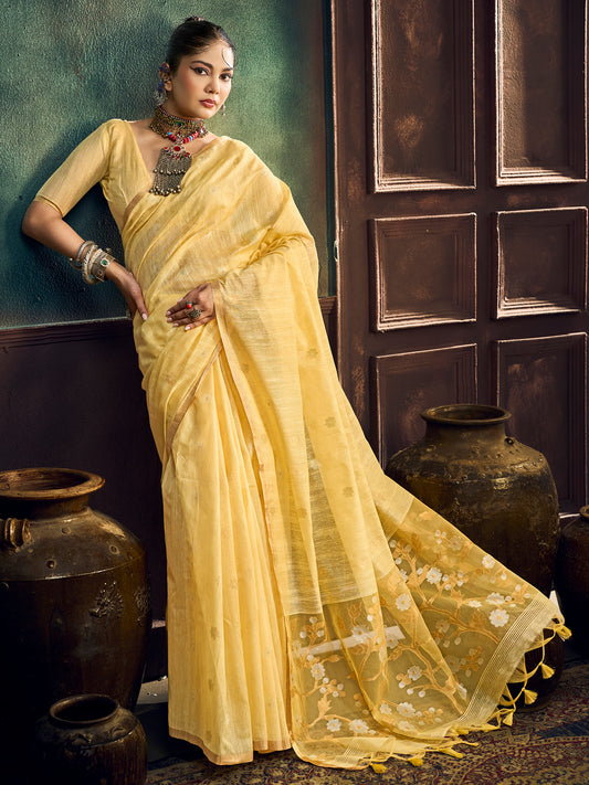 Woman wearing yellow muga cotton saree with zari butta (metallic motif) work and yellow blouse