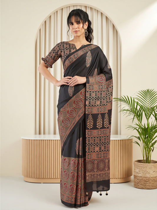 Woman wearing black silk blend saree with traditional indian motif work and black blouse