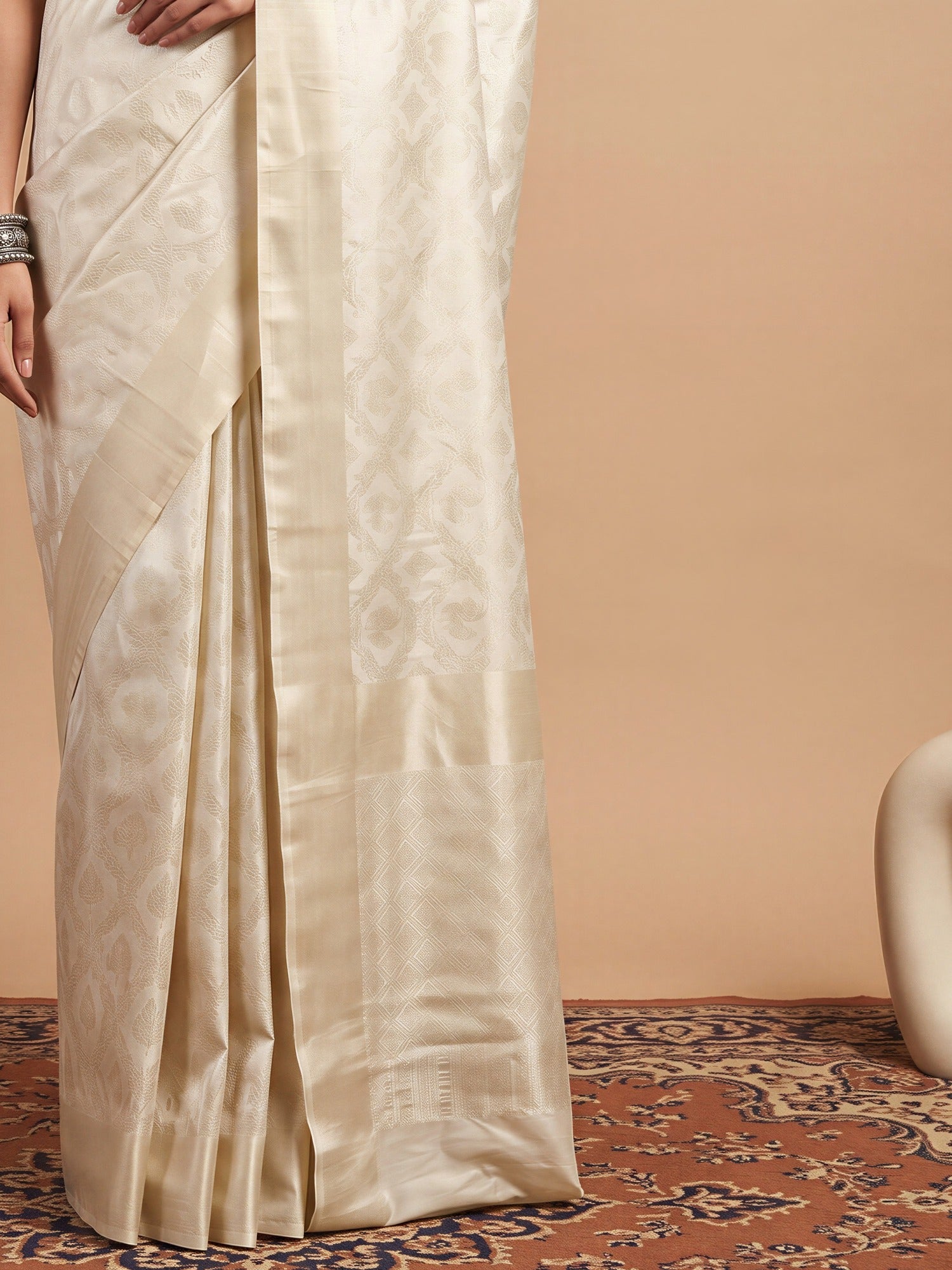 Pallu detail of off white silk blend saree showing woven motif design and zari border