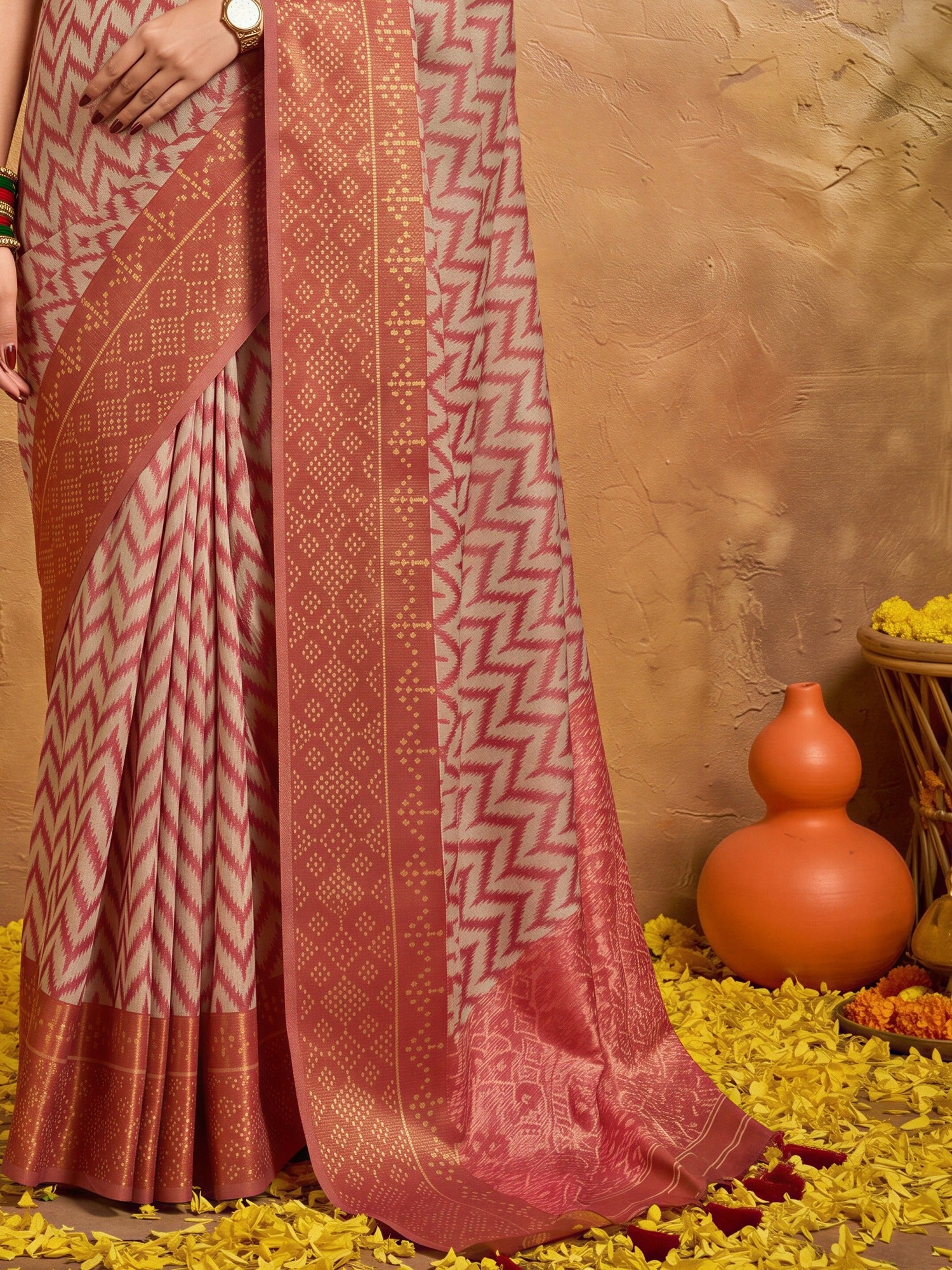 Pallu detail of orange viscose saree showing geometric pattern design and zari border
