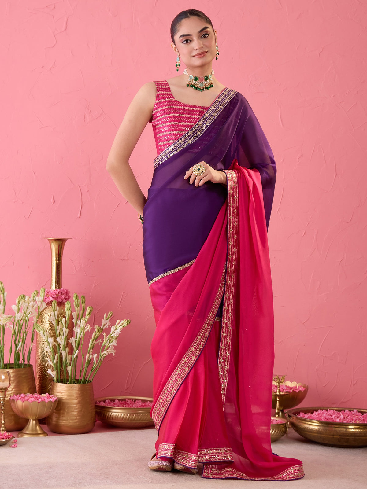 Woman wearing pink pure georgette ready to wear saree with ornamented surface design and pink blouse