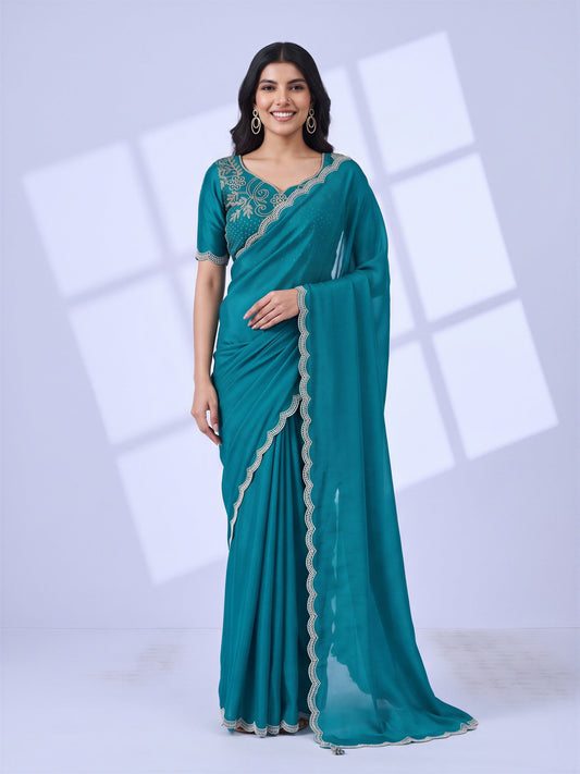 Woman wearing light blue chiffon saree with embroidered motif work and light blue blouse