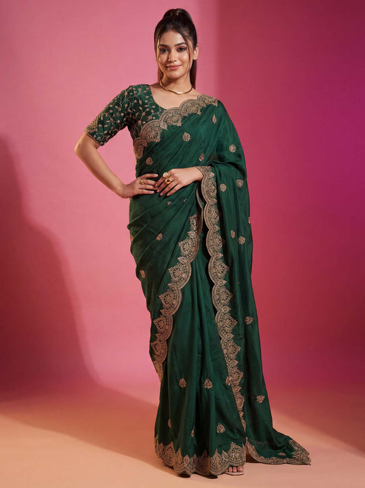 Woman wearing green georgette saree with embroidered motif work and green blouse