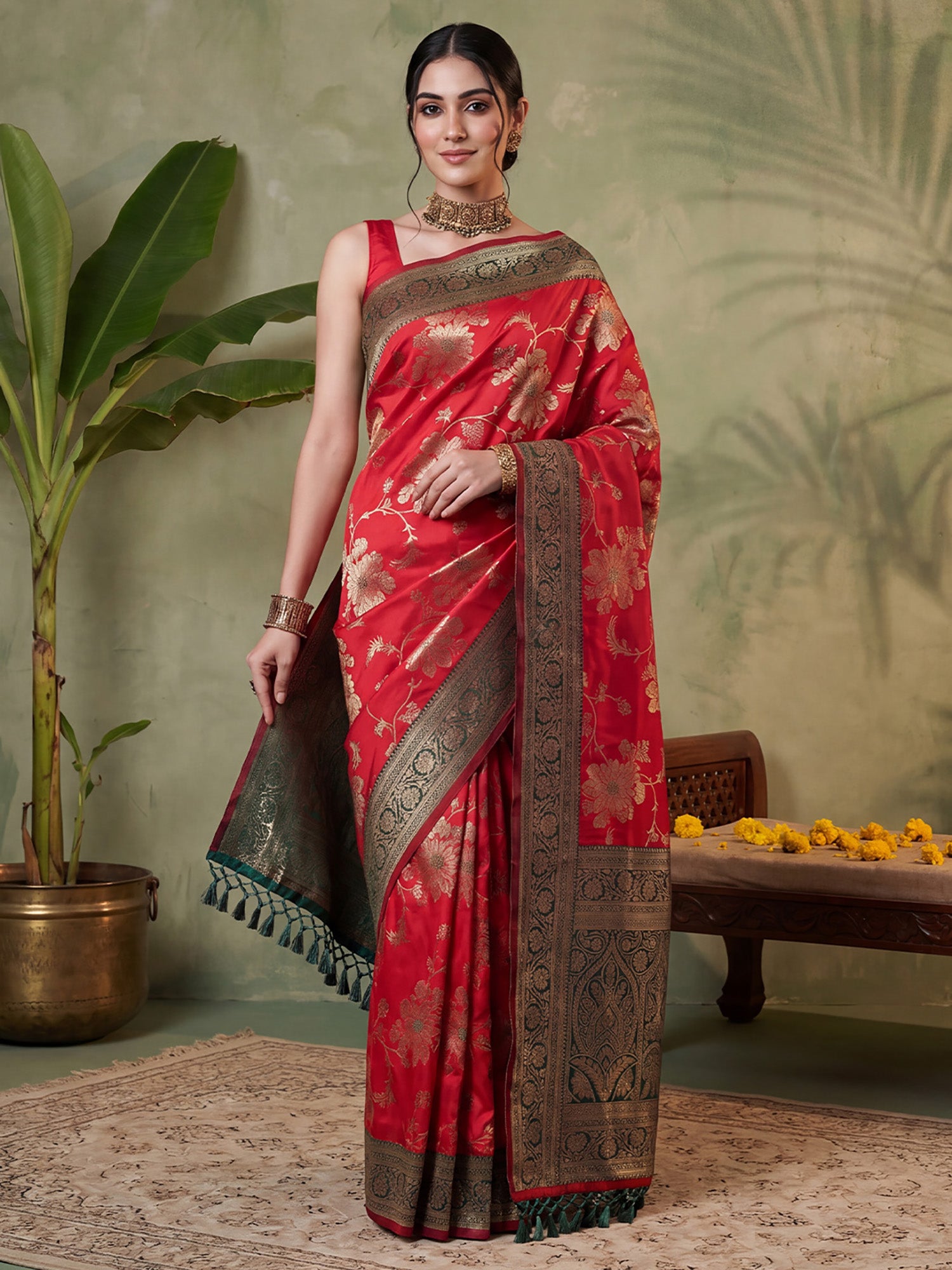 Woman wearing red silk blend saree with all-over floral design and green blouse