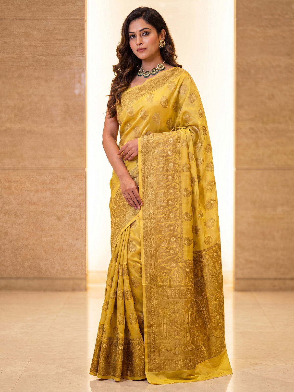 Woman wearing yellow silk blend saree with zari butta (metallic motif) work and yellow blouse