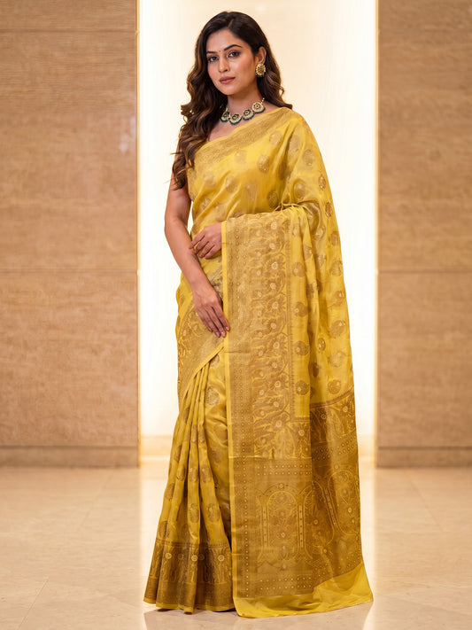Woman wearing yellow silk blend saree with zari butta (metallic motif) work and yellow blouse
