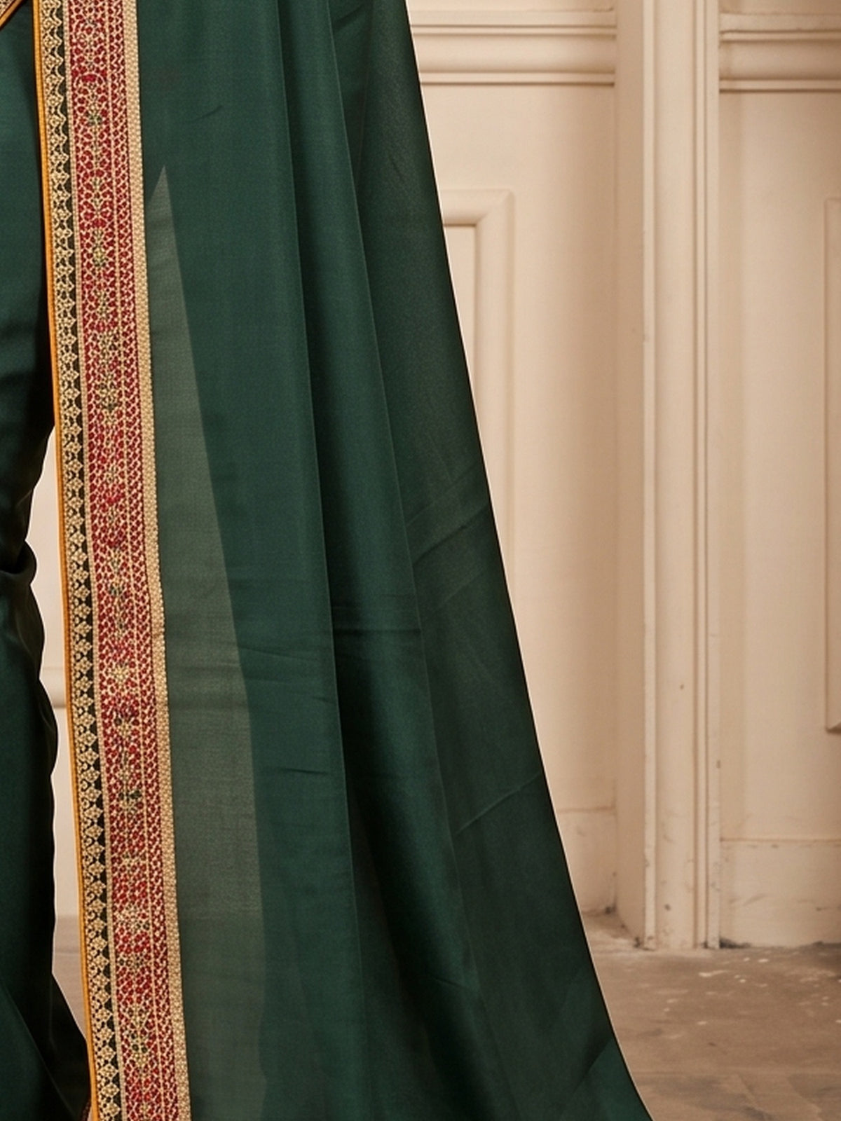 Pallu detail of green vichitra silk saree showing clean solid-tone finish and embellished border