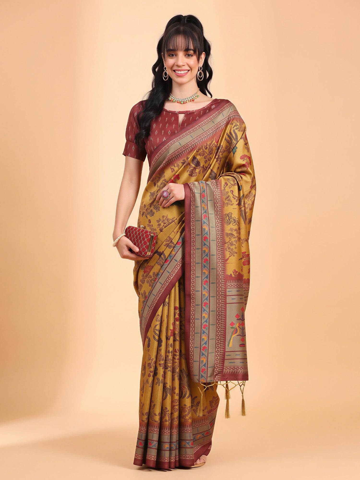 Woman wearing mustard cotton blend saree with botanical floral and leaf design and maroon blouse