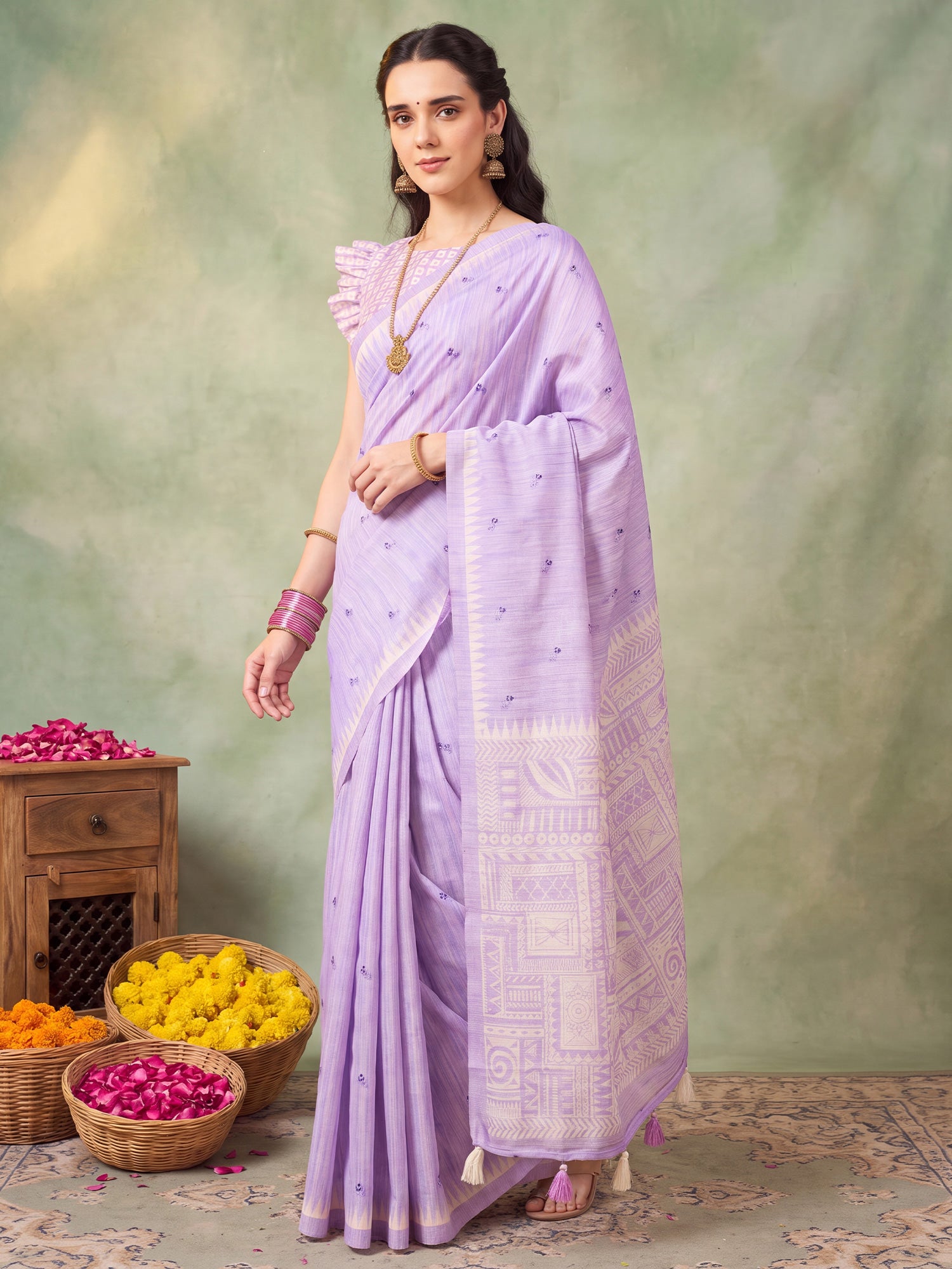 Woman wearing lavender silk blend saree with embroidered motif work and lavender blouse