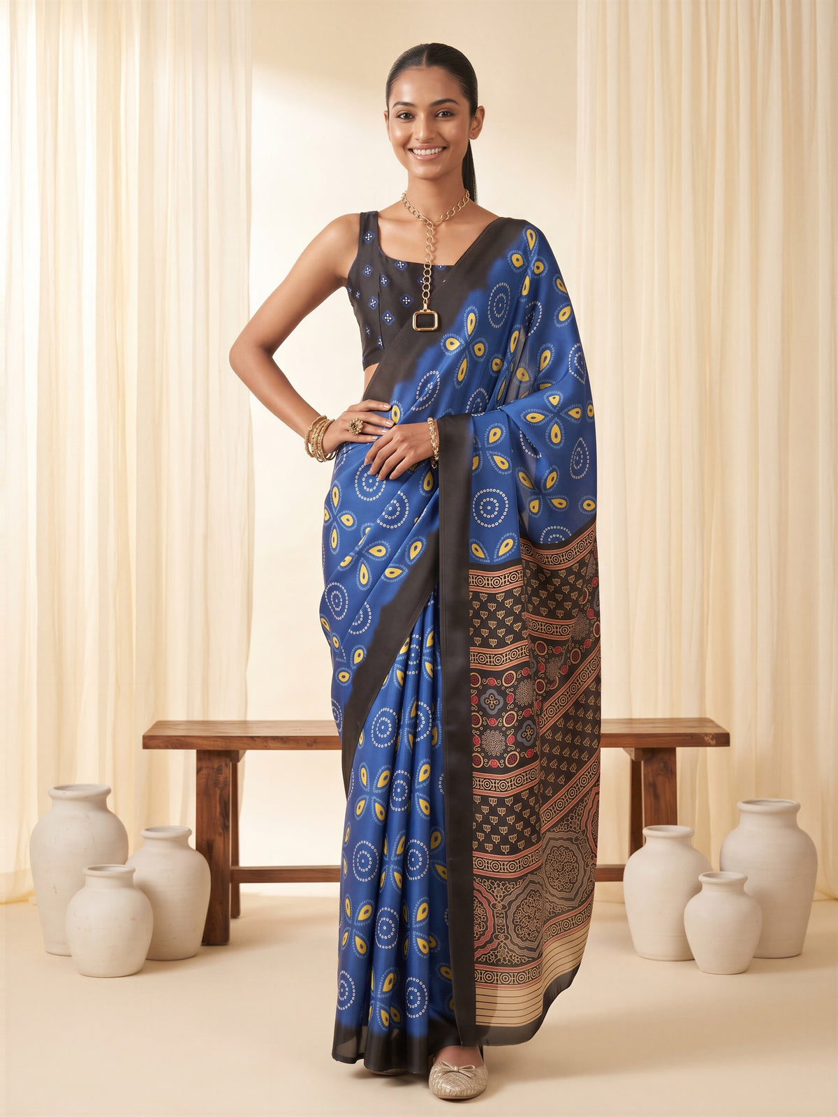 Woman wearing blue satin saree with bagh block-print motif work and black blouse
