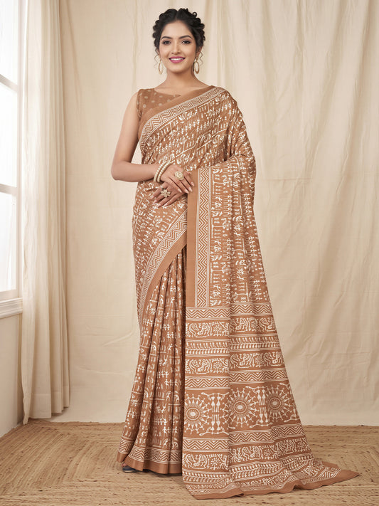 Woman wearing camelbrown dola silk saree with warli folk-art figures and camel brown blouse