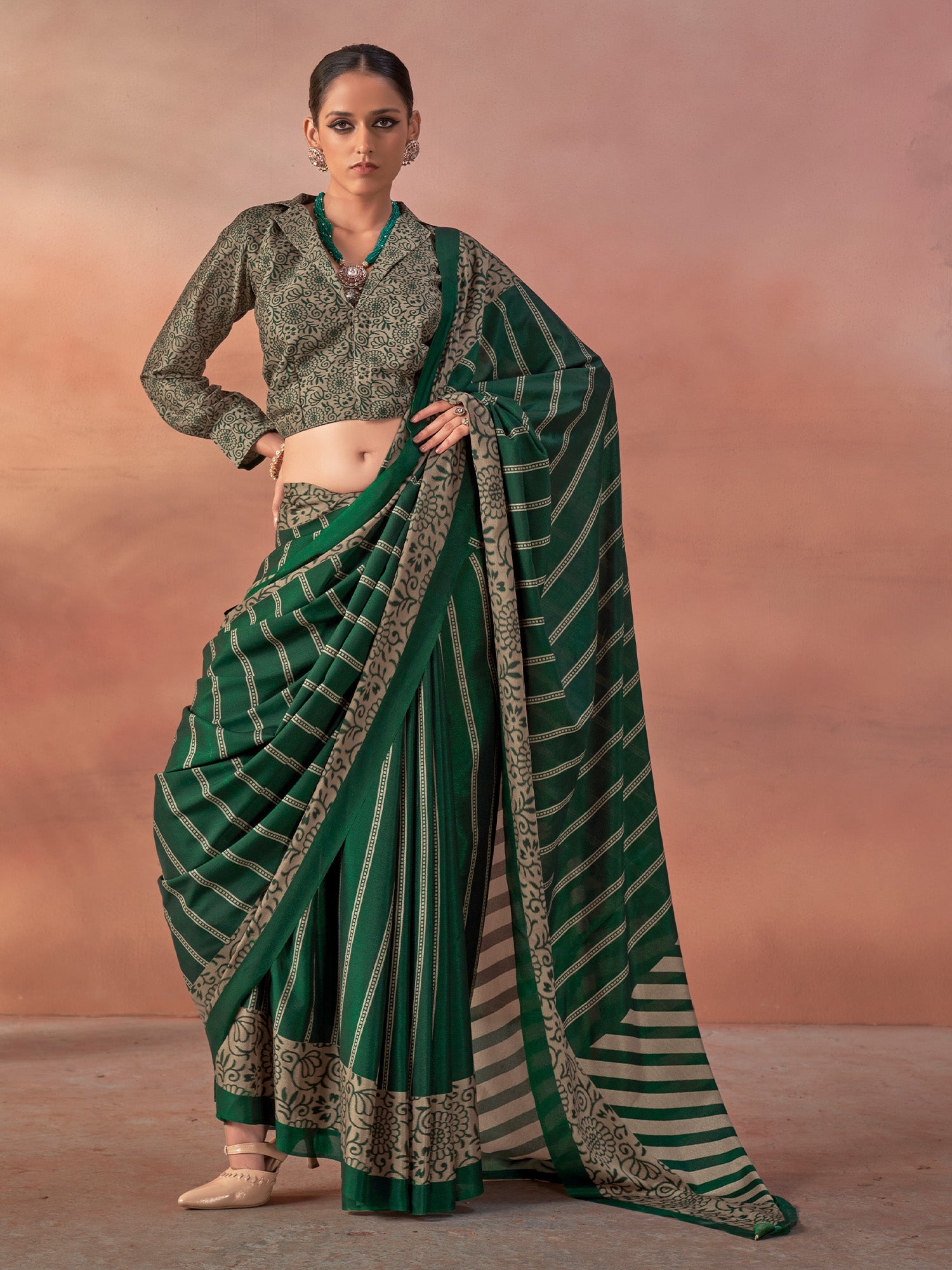 Woman wearing green silk blend saree with traditional indian motif work and green blouse