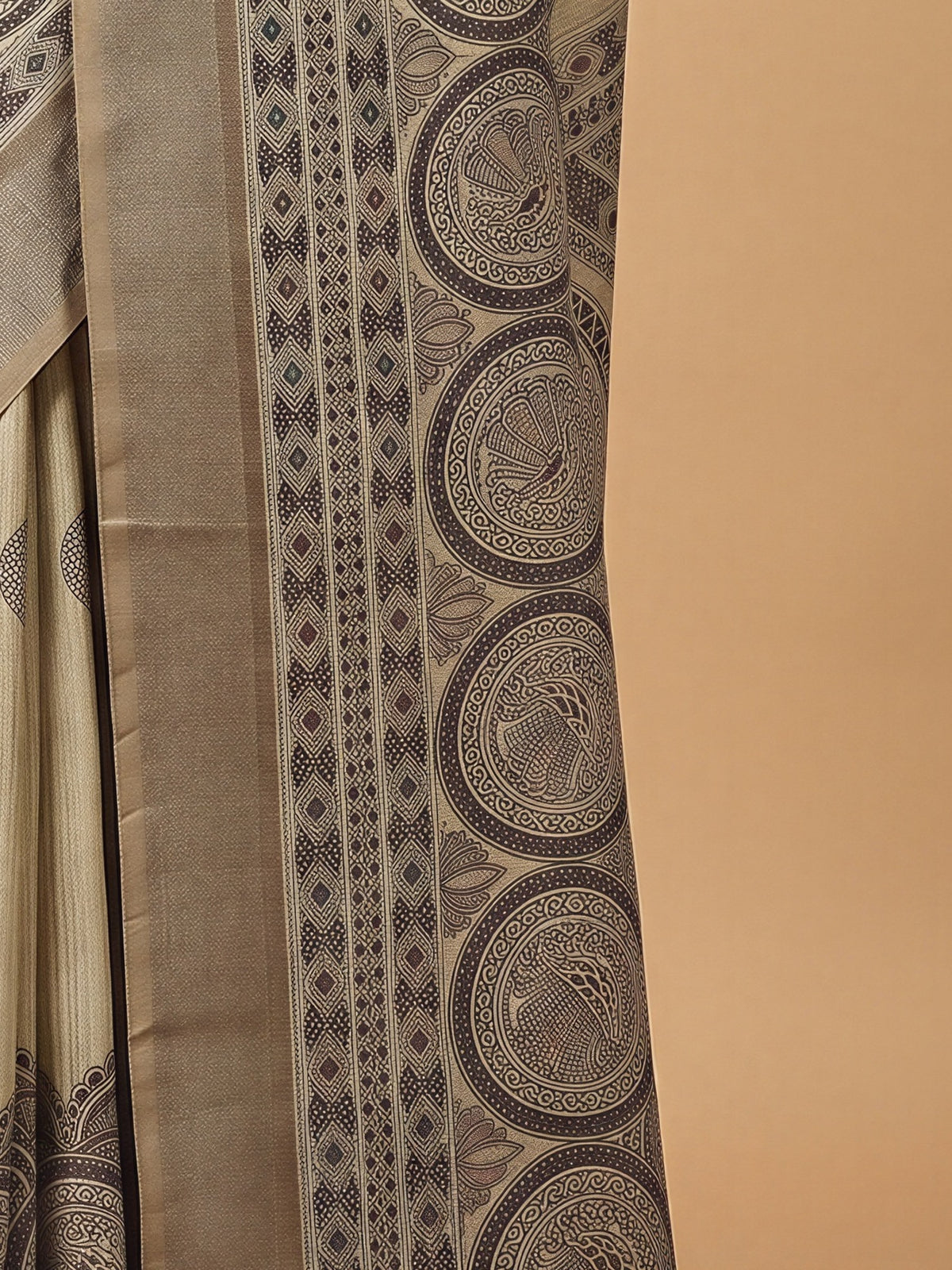 Pallu detail of beige satin silk saree showing hand block-printed motifs and zari border