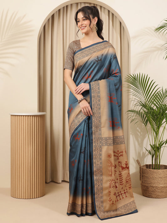 Woman wearing blue silk blend saree with tribal folk-art motifs and beige blouse