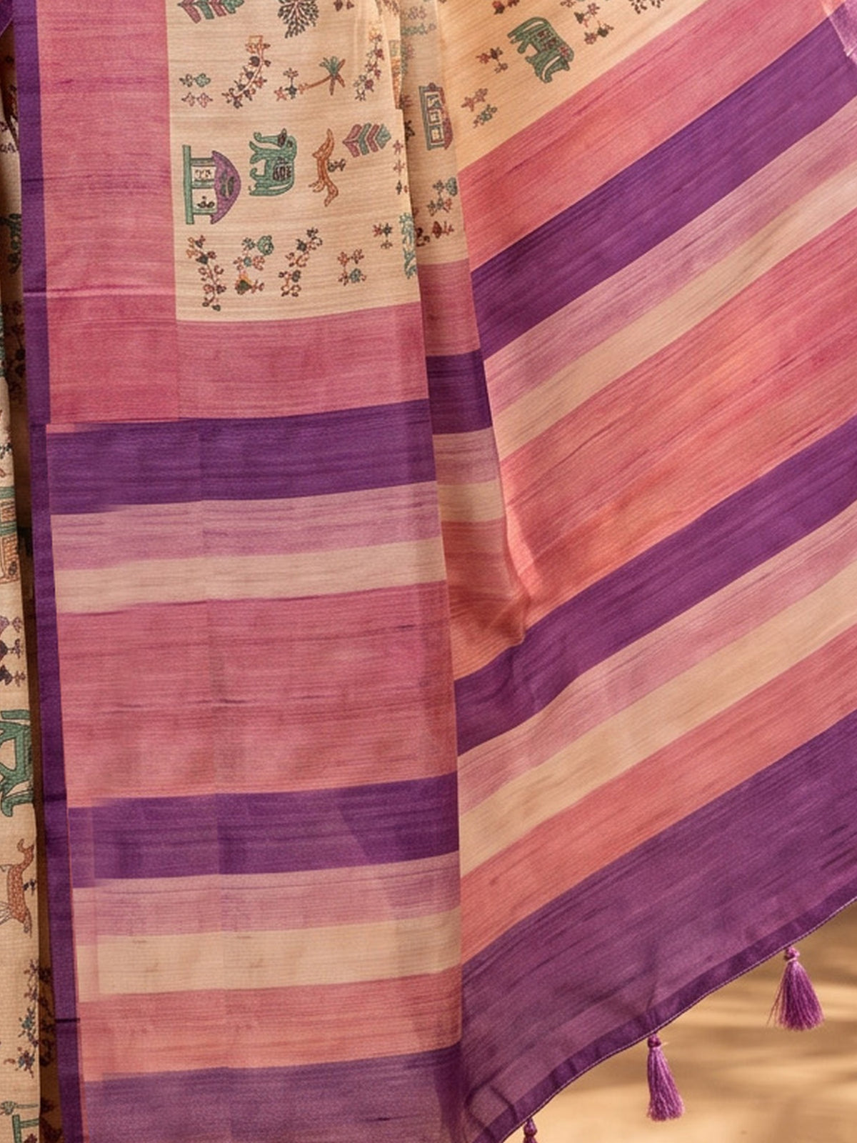 Pallu detail of beige soft silk saree showing tribal folk-art motifs and printed border
