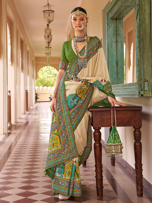 Woman wearing beige silk blend saree with traditional indian motif work and green blouse