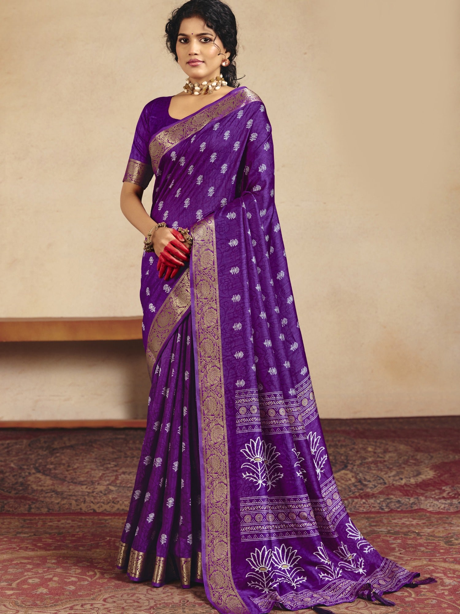 Woman wearing purple tussar silk saree with traditional indian motif work and purple blouse