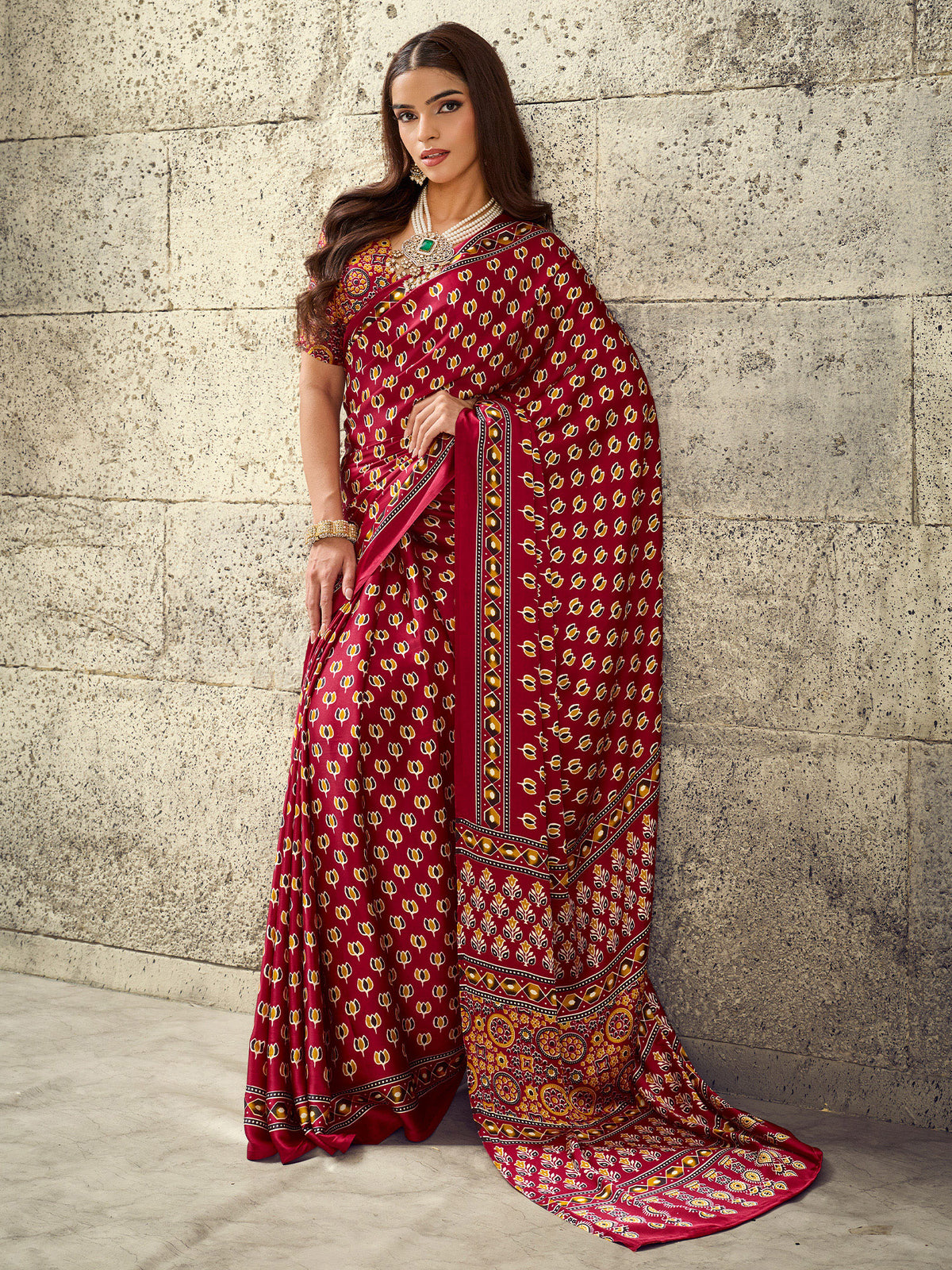 Woman wearing maroon satin saree with ajrak block-print motif work and maroon blouse