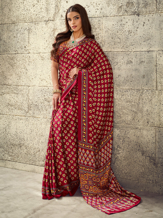 Woman wearing maroon satin saree with ajrak block-print motif work and maroon blouse