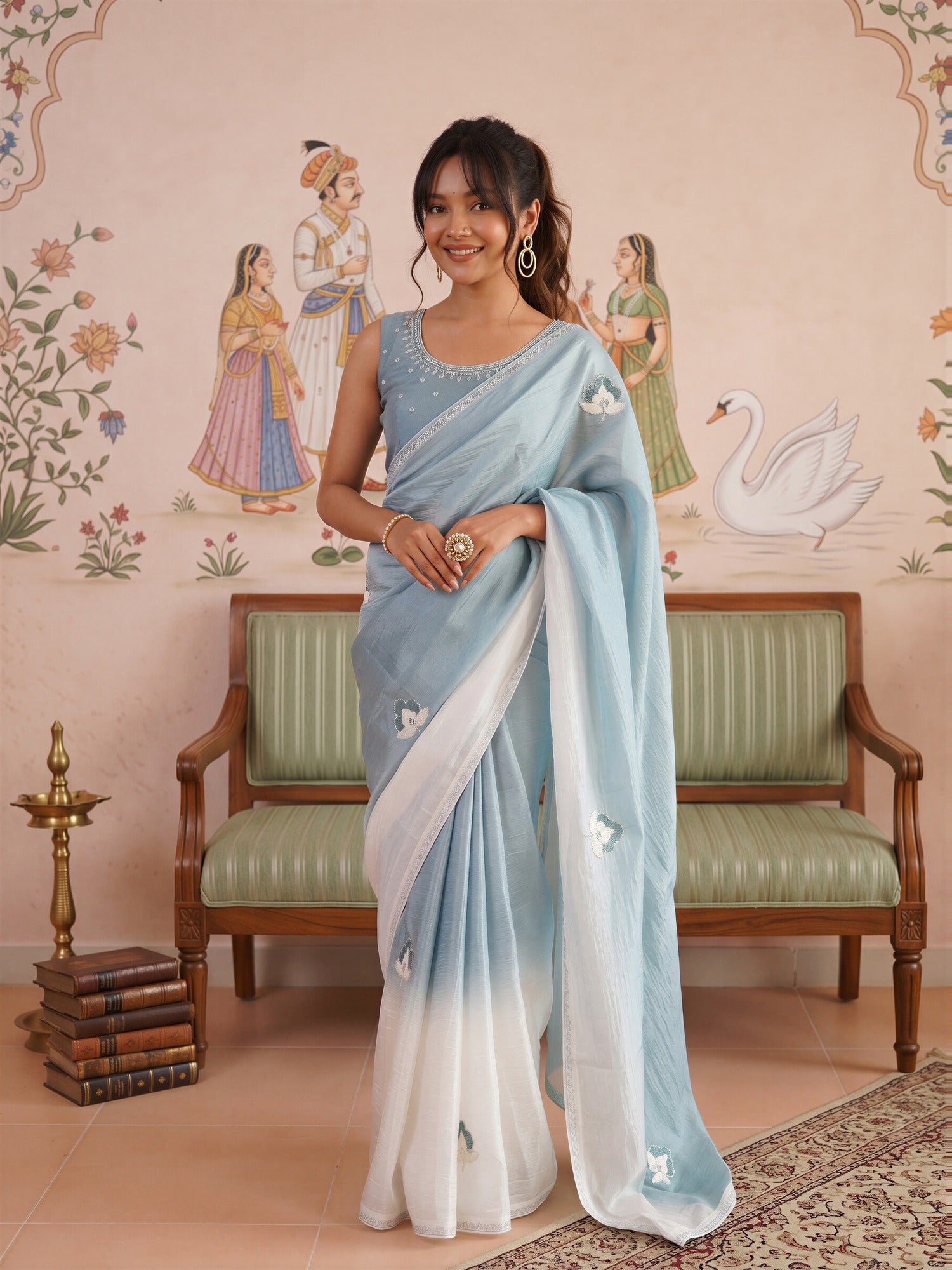 Woman wearing light blue paper silk saree with ombre graded colour work and light blue blouse