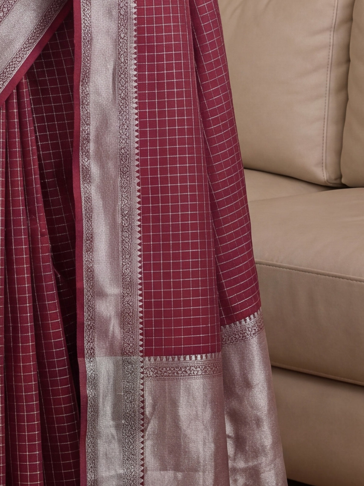 Pallu detail of maroon banarasi silk saree showing checked pattern design and zari border