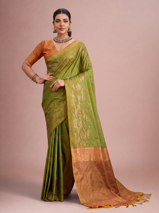 Woman wearing green tussar silk saree with traditional indian motif work and mustard blouse