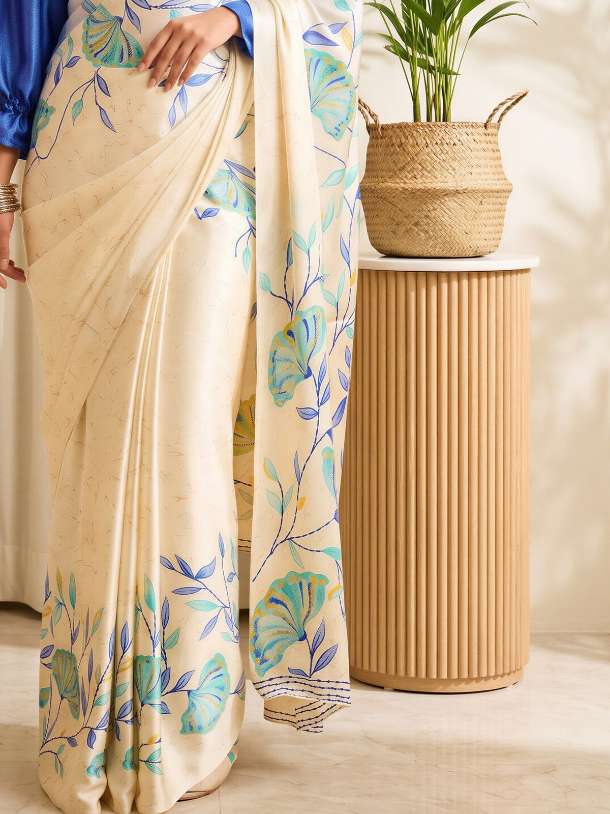 Pallu detail of beige satin saree showing botanical floral and leaf design and solid border