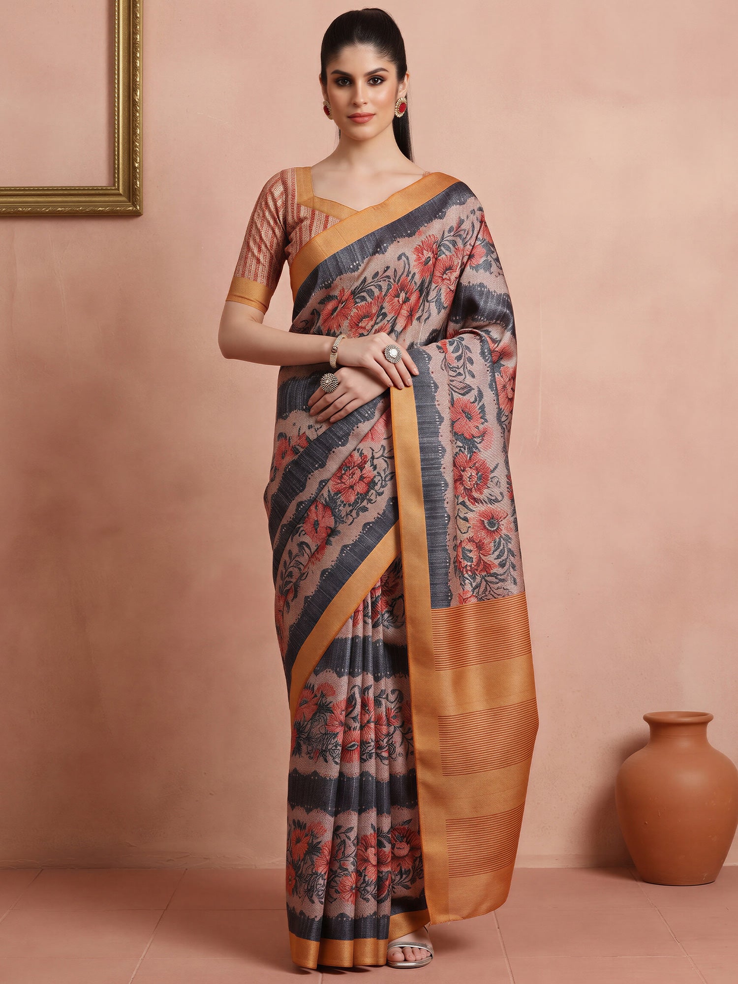 Woman wearing rust cotton blend saree with all-over floral design and rust blouse
