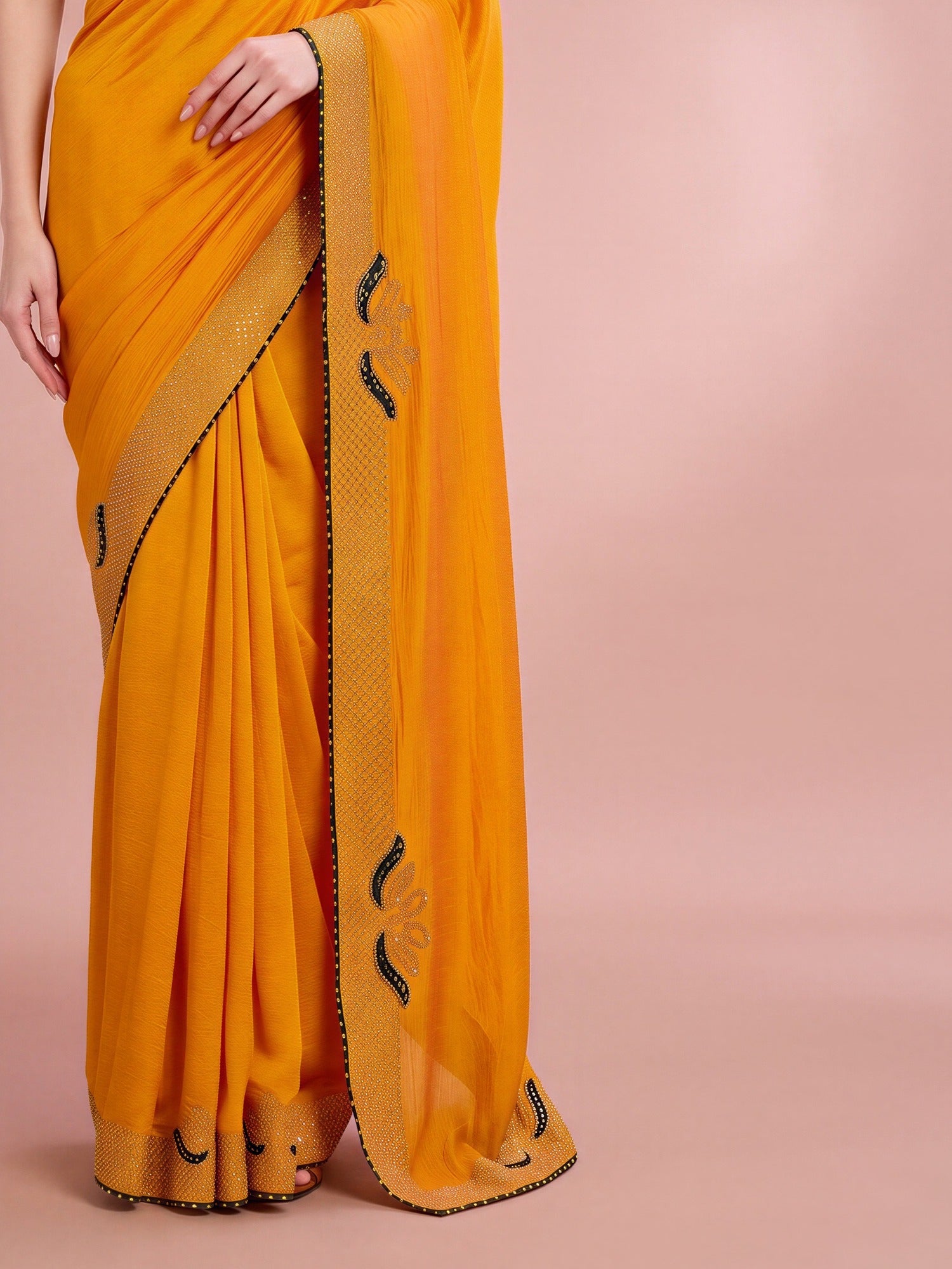 Pallu detail of yellow vichitra silk saree showing ornamented surface design and embellished border