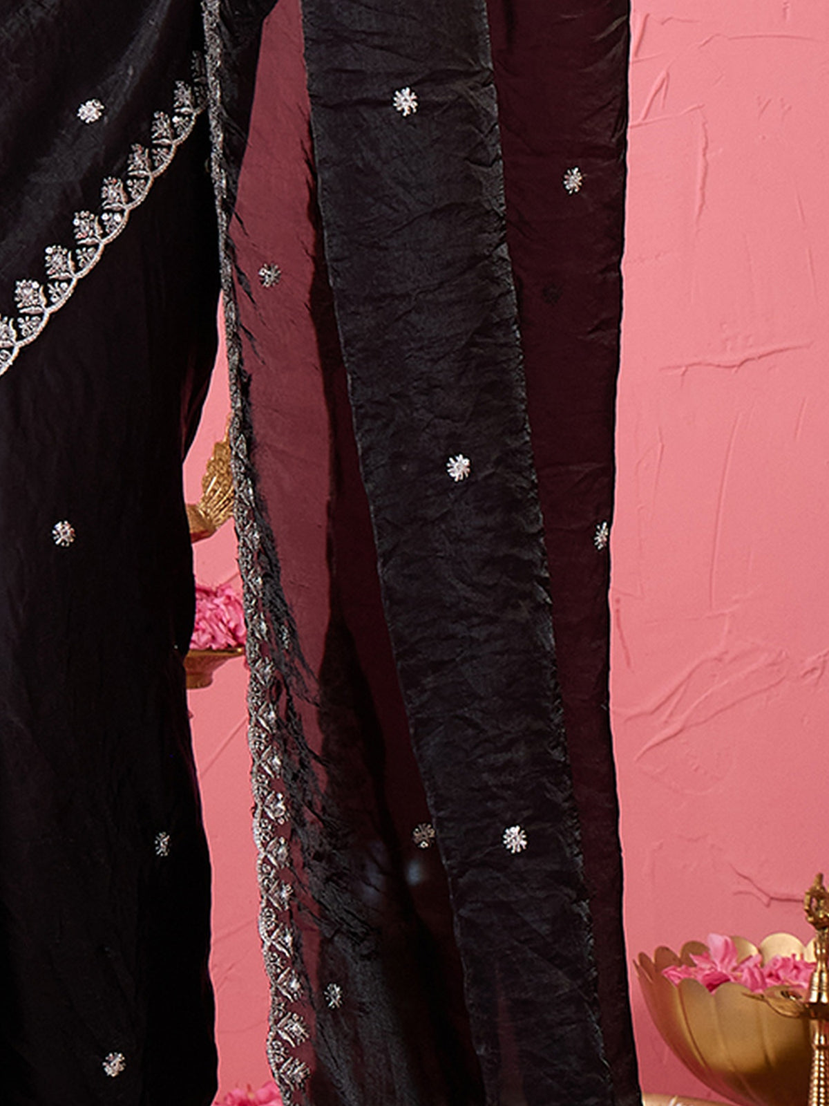Pallu detail of black paper silk saree showing embroidered motif work and embroidered border