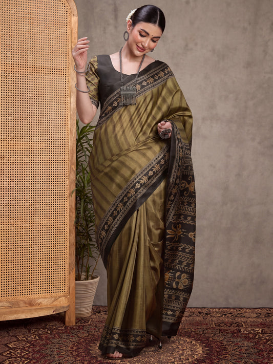 Woman wearing olive silk blend saree with striped pattern design and green blouse