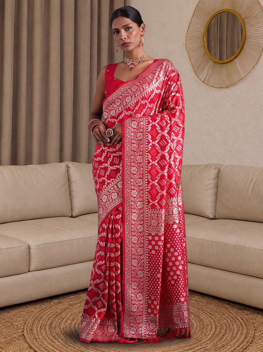 Woman wearing pink dola silk saree with woven motif design and pink blouse
