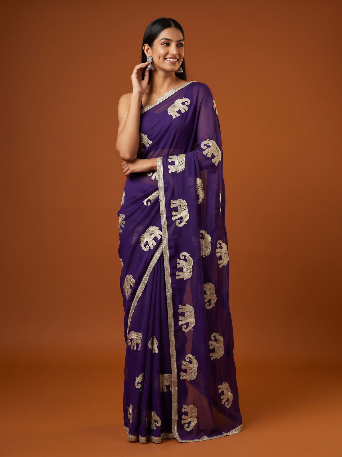 Woman wearing purple georgette saree with embroidered motif work and purple blouse