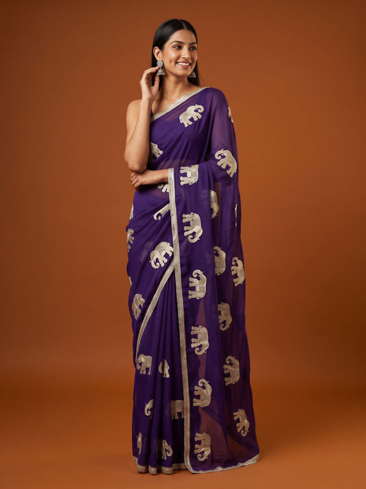 Woman wearing purple georgette saree with embroidered motif work and purple blouse