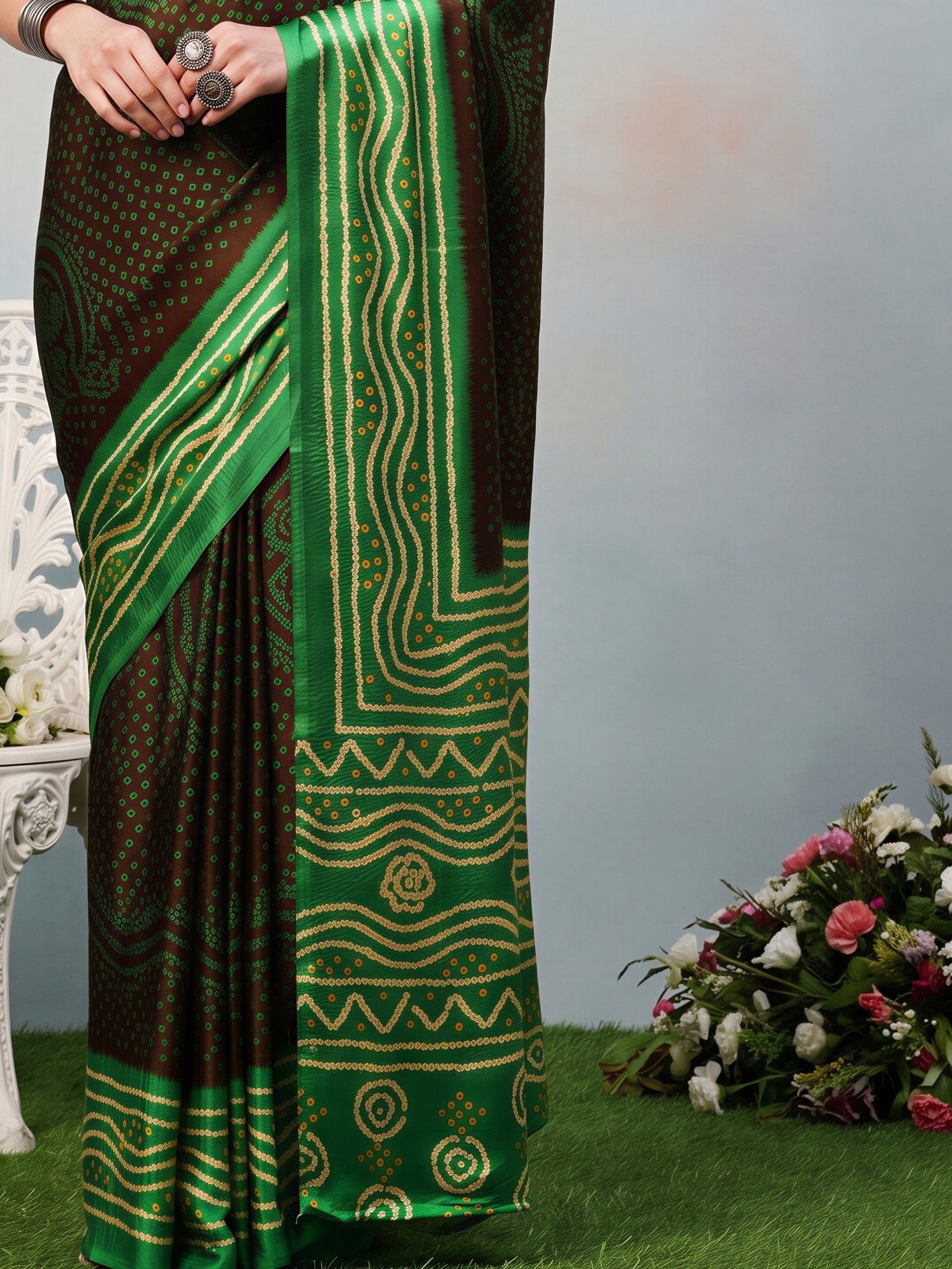 Pallu detail of brown satin silk saree showing bandhani tie-dye dot work and printed border