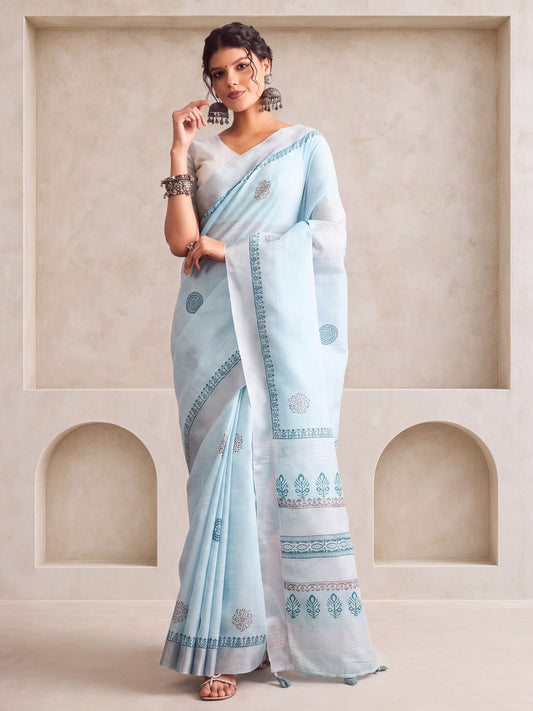 Woman wearing light blue linen saree with bagh block-print motif work and light blue blouse