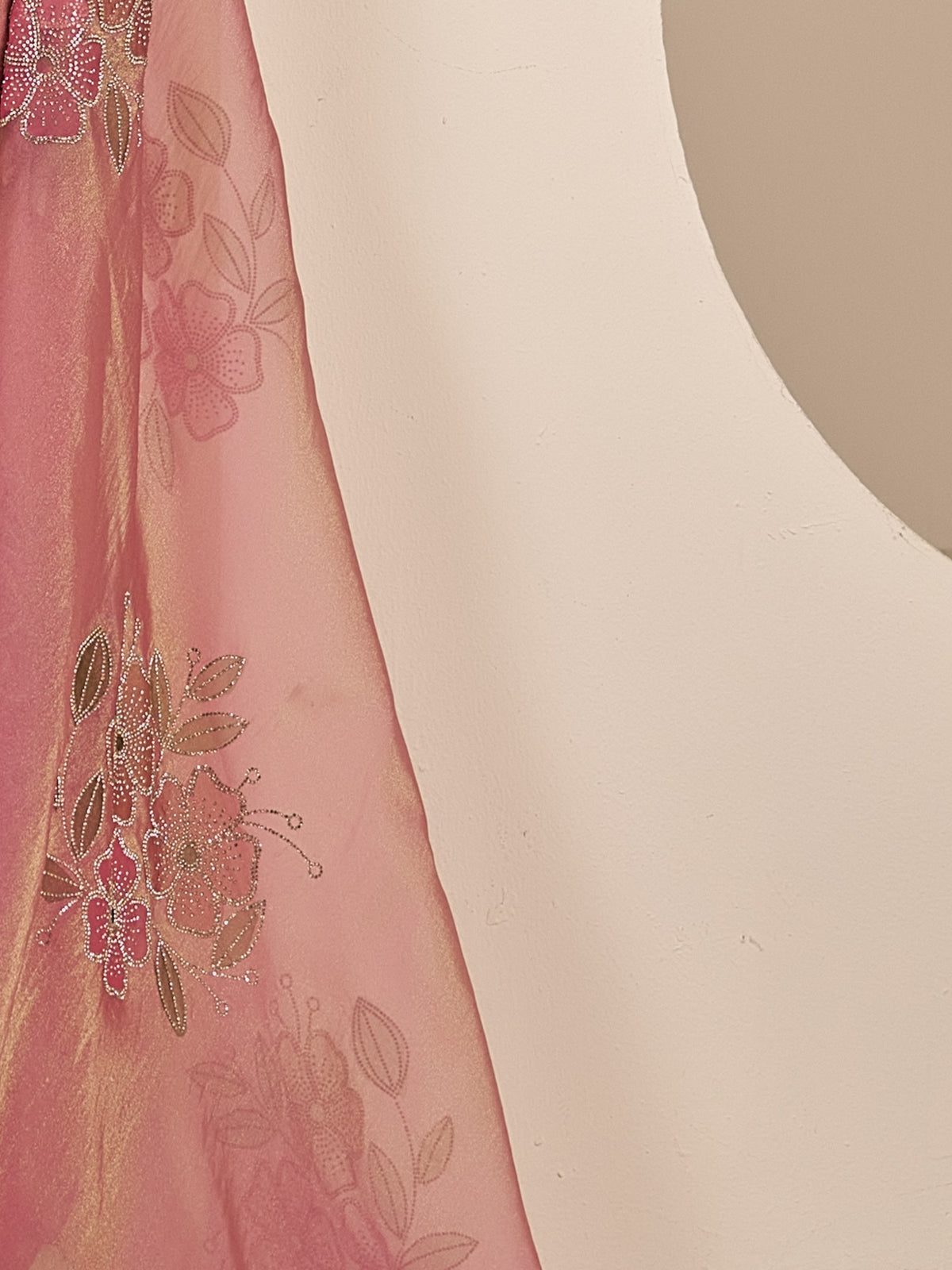 Pallu detail of pink organza saree showing ornamented surface design and scallop border