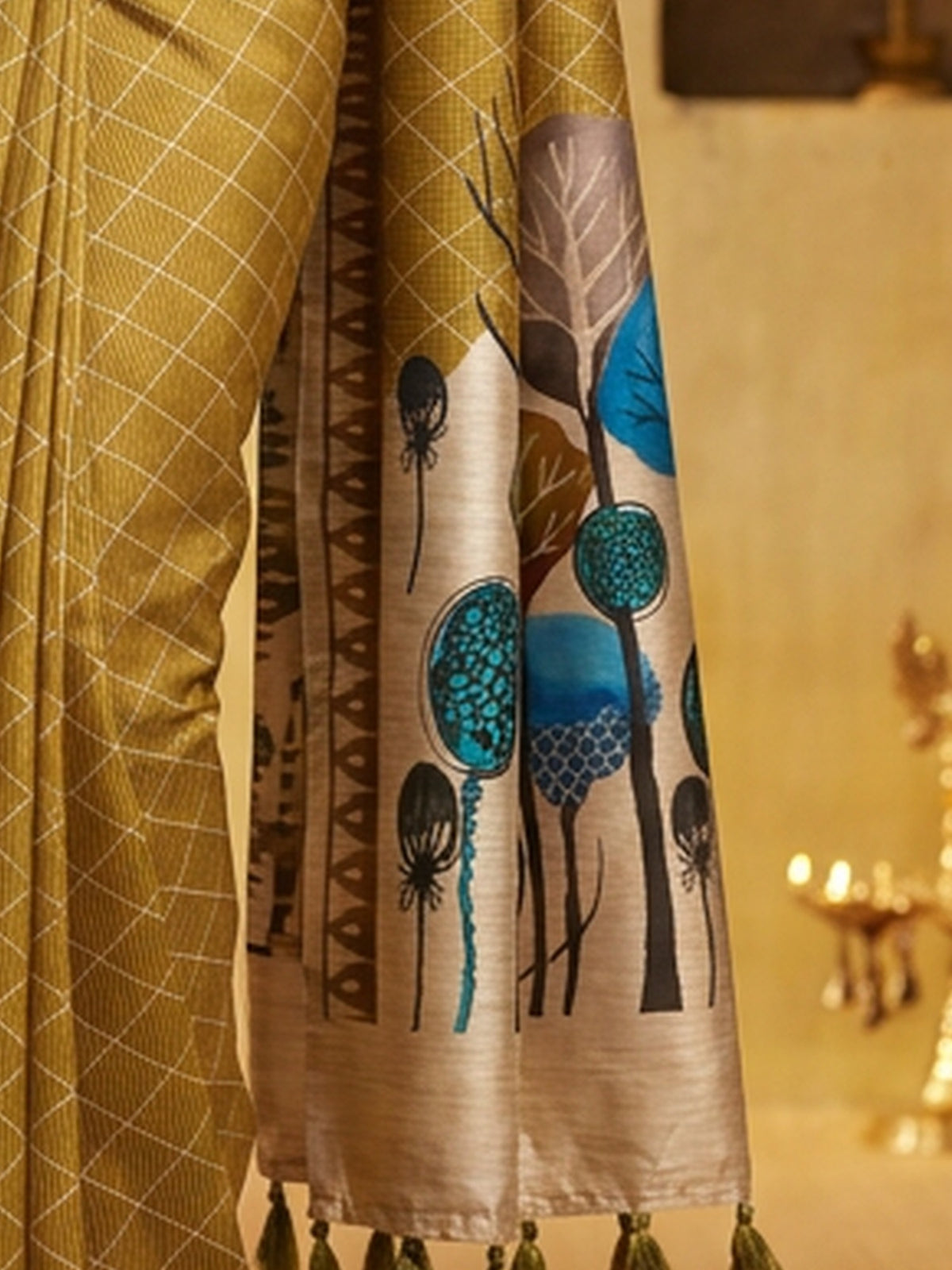 Pallu detail of olive soft silk saree showing geometric pattern design and printed border