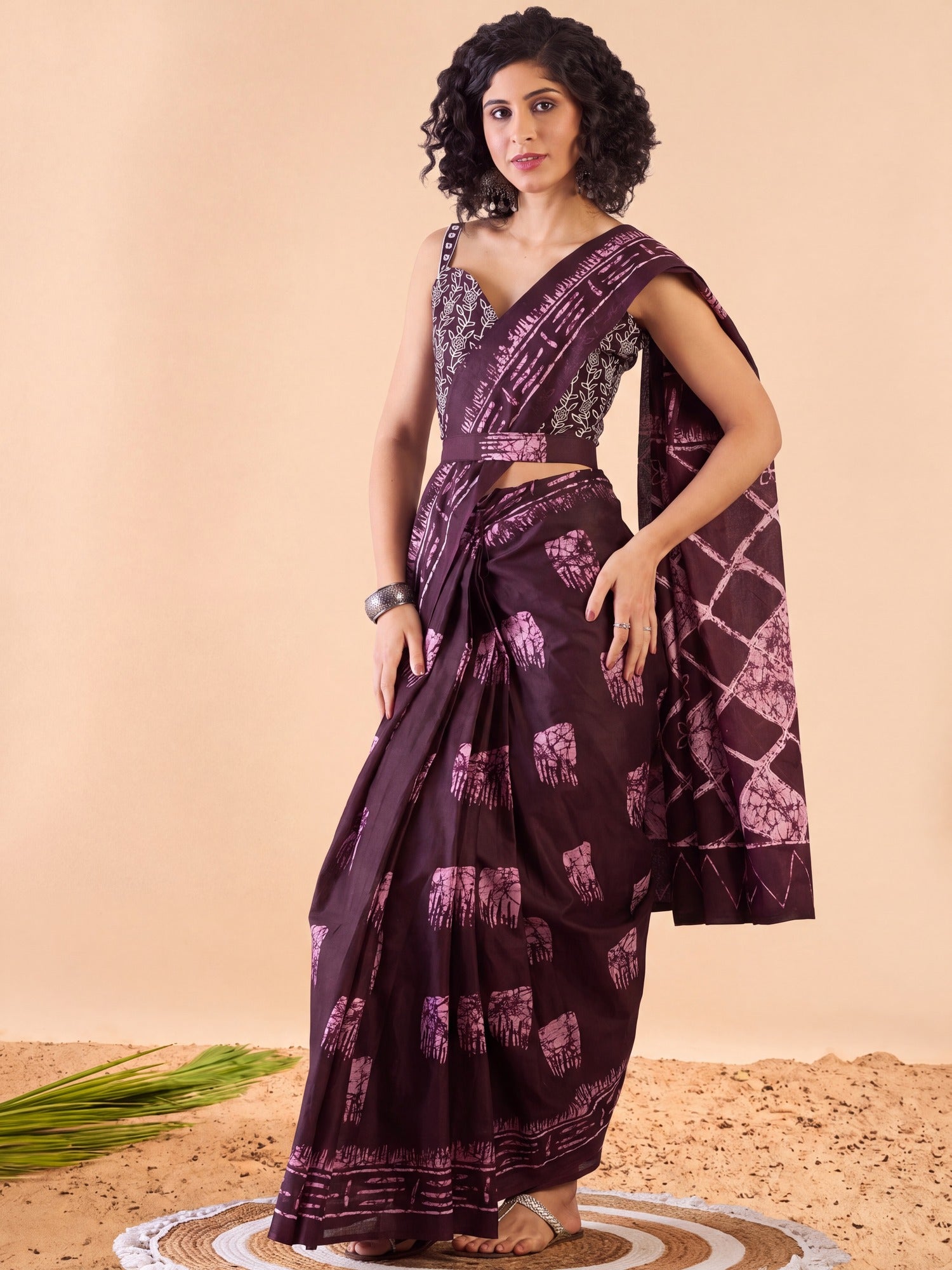 Woman wearing burgundy cotton saree with bagru hand block-print work and burgundy blouse
